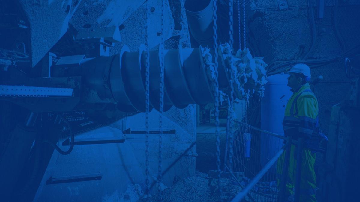 man standing in front of a boring machine